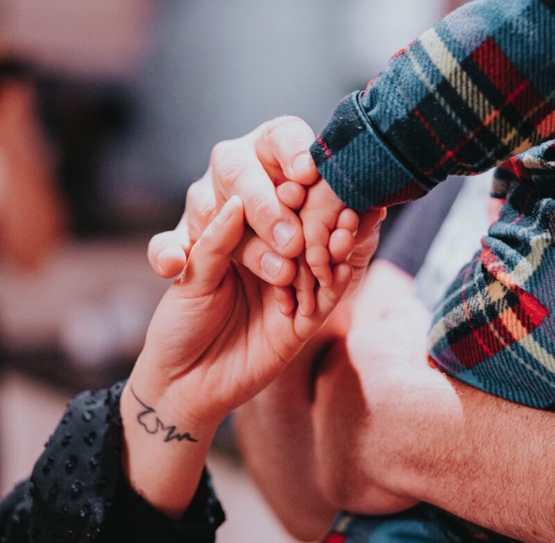 a couple holding hands while holding each other